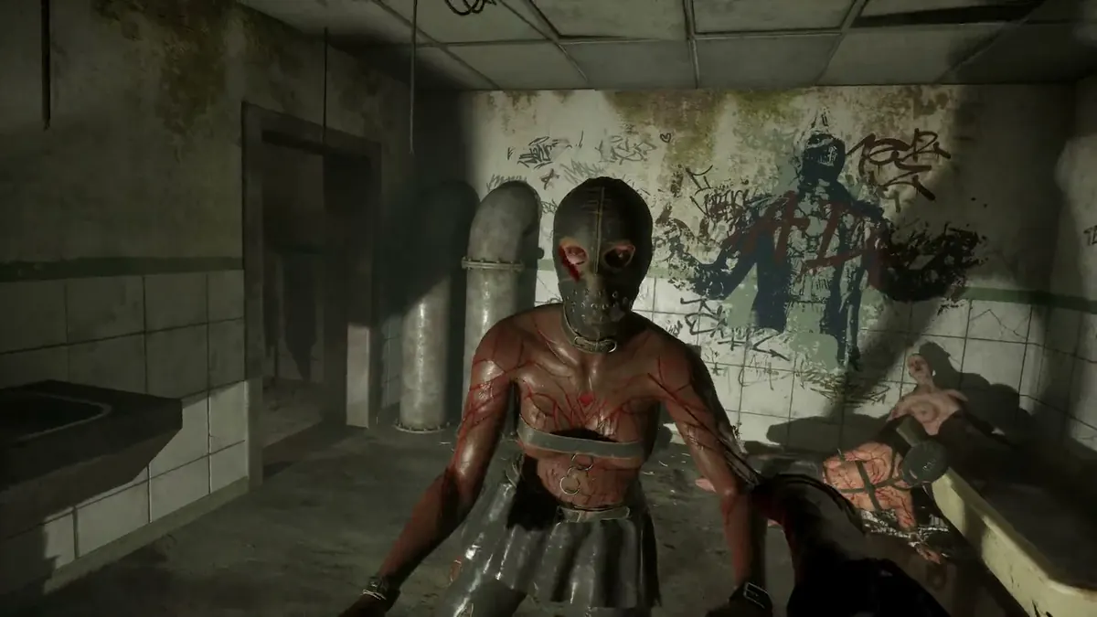 Masked enemy advancing through a graffiti-covered washroom in Hellraiser: Revival