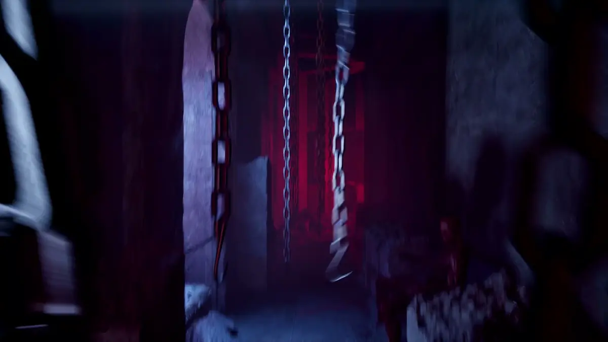 Hanging chains lit by red light in the opening Labyrinth passage