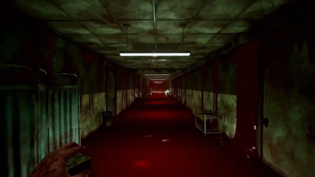 First-person view down a green-tiled ward corridor flooded with red light
